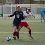 a couple of men playing a game of soccer