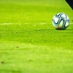 man playing soccer game on field